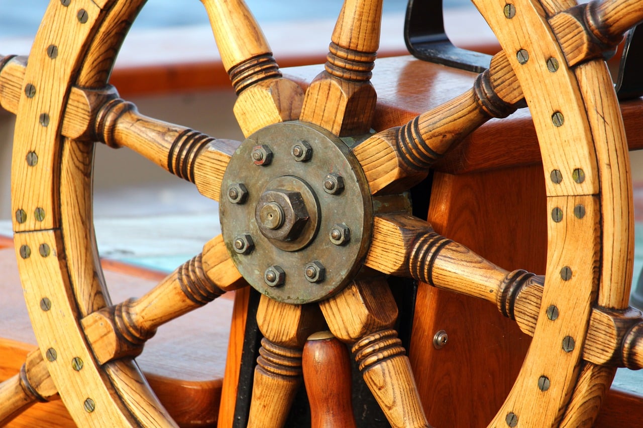 a wooden steering wheel on a boat