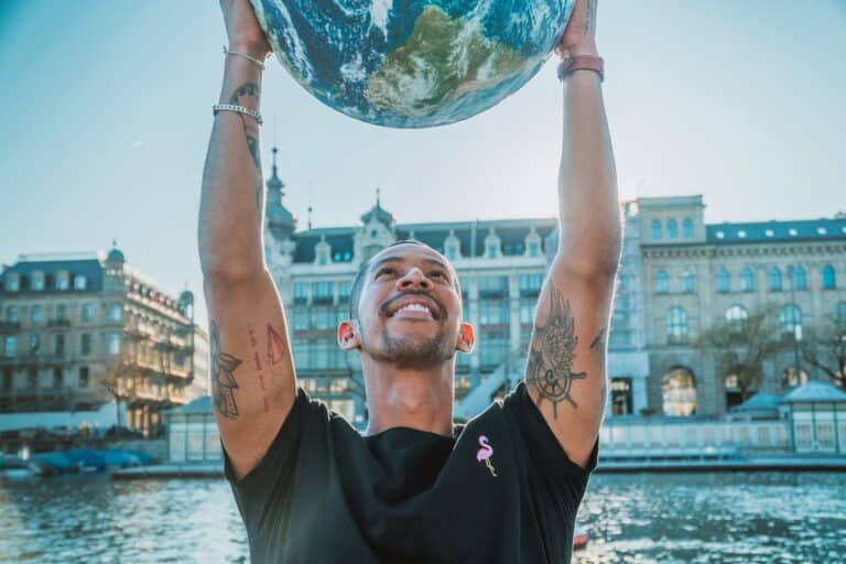 a man holding a globe above his head